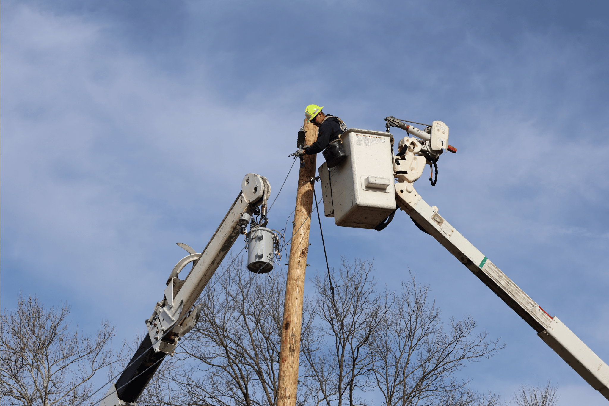 Lineman installing an electric pole 