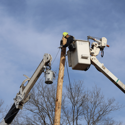 Lineman installing an electric pole 